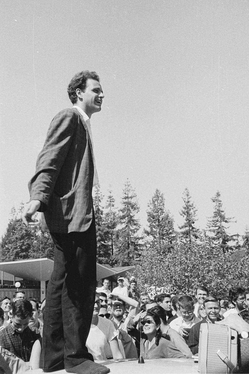 Mario Savio (in socks) speaking from top of police car by Steven Marcus